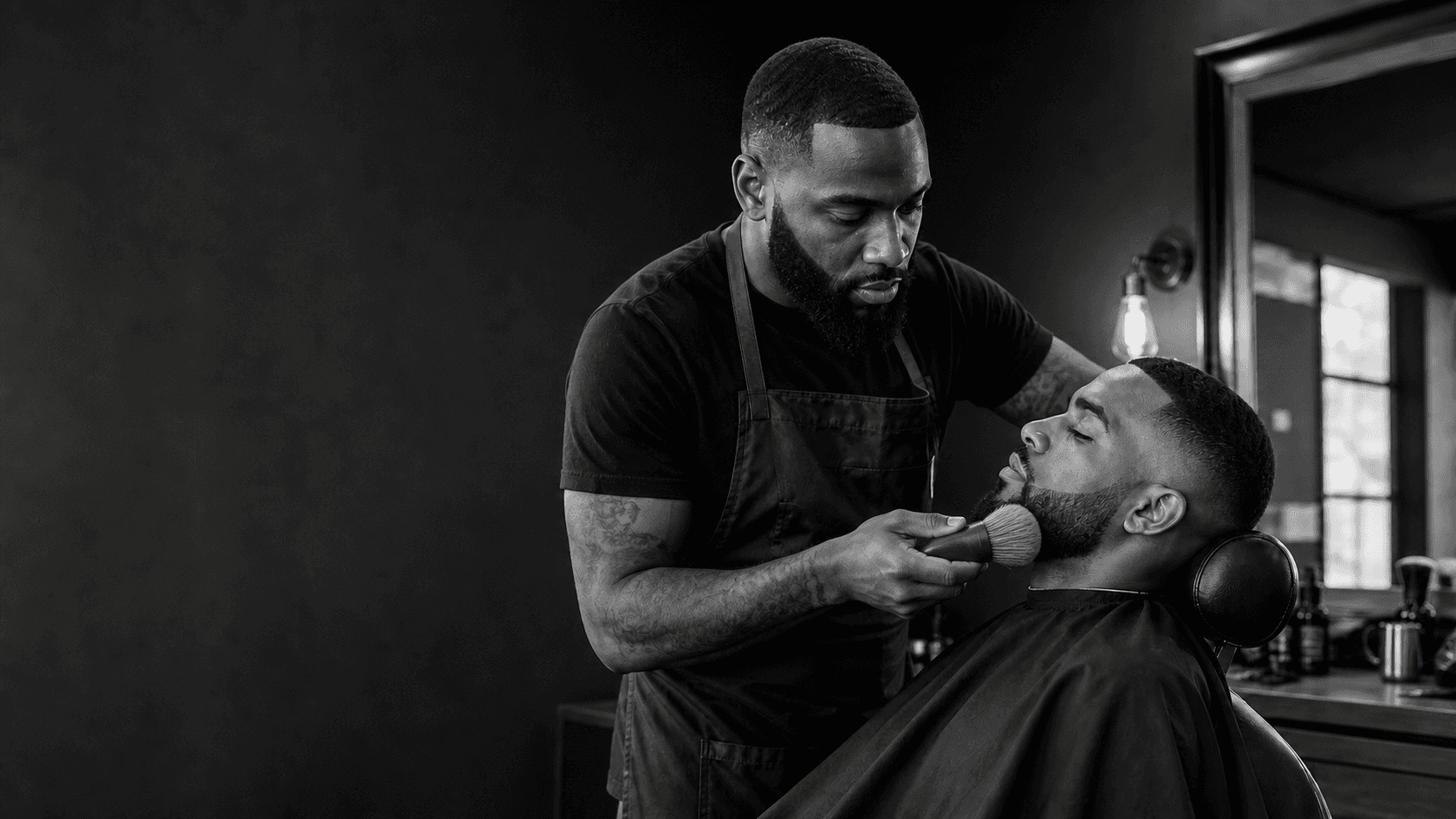 A barber gently brushing a client’s beard during an appointment